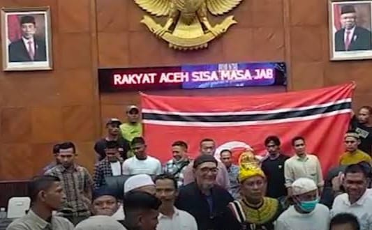 Pendukung Saiful Bahri saat mengibarkan Bendera Bintang Bulan di gedung utama DPRA, Jum'at (13/5/2022)