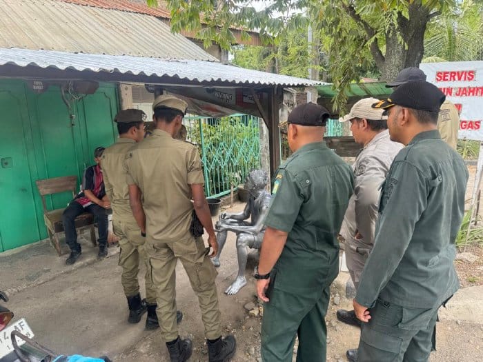 Anggota Satpol PP-WH Aceh Besar megamankan manusia silver yang mencoba beroperasi di Simpang Ajun, Kecamatan Darul Imarah, Aceh Besar, Sabtu (3/5). (Foto: Dok. Satpol PP-WH Aceh Besar)