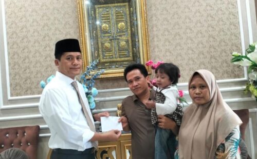 Bupati Aceh Selatan Mirwan MS menyambut seorang pasien yang menderita bocor jantung dan menyerahkan bantuan, Kamis, 18 September 2025.