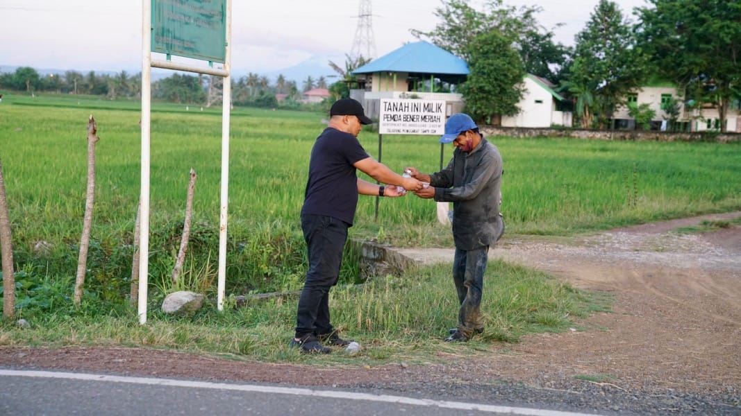 Pj Bupati Aceh Besar Muhammad Iswanto bersama stafnya berbagi takjil kepada pengendara yang melintas di Jembatan Cot Iri -Jalan Teungku Hasan Bakoy, Kecamatan Ingin Jaya, Rabu petang (29/3)