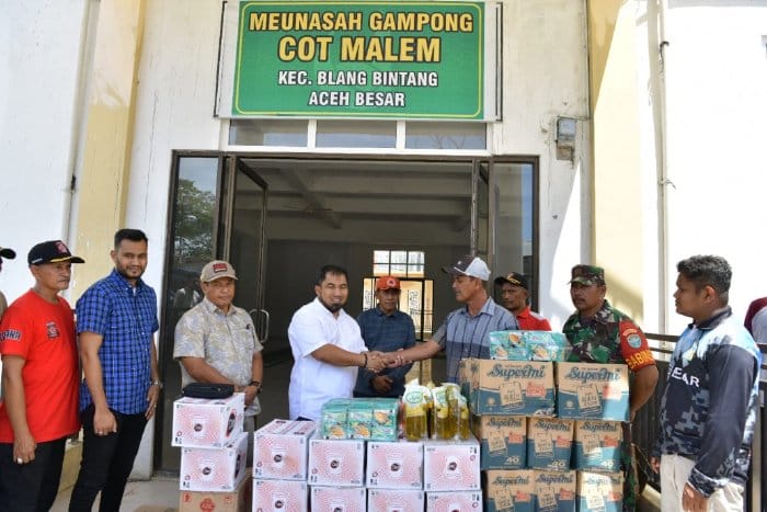 Pj Bupati Aceh Besar Muhammad Iswanto didampingi Kadis Sosial Bahrul Jamil, Kalak BPBD Aceh Besar Ridwan Jamil serta Camat Blang Bintang M Kamil Zuhri menyerahkan bantuan kepada korban kebakaran di Gampong Cot Malem, Blang Bintang, Rabu (28/6)