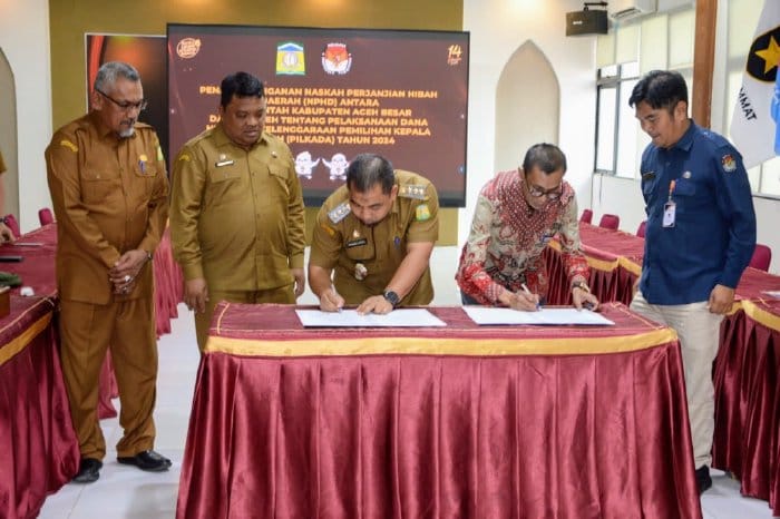 Pj Bupati Aceh Besar Muhammad Iswanto didampingi Sekda Sulaimi bersama Ketua KIP Aceh, Saiful menandatangani NPHD tentang dana hibah penyelenggaraan Pilkada 2024 di Kantor KIP Aceh, Selasa (21/11)