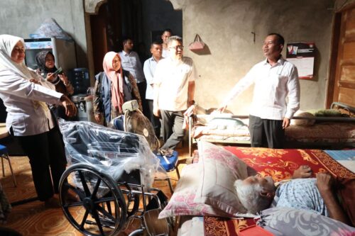 Kadis Sosial Aceh Muslem Yacob menyerahkan bantuan kursi roda dan tongkat ketiak untuk dua warga Gampong Lampulo, Kecamatan Kuta Alam, Banda Aceh, Rabu (10/1)